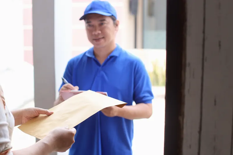 Courier handing over a parcel of documents